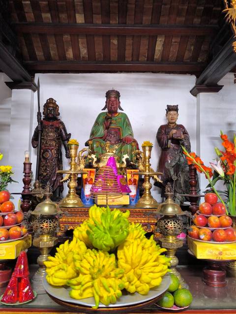 Colorful shrine with statues and offerings.