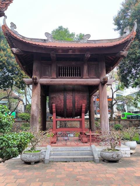Large wooden drum in an open pavillion.