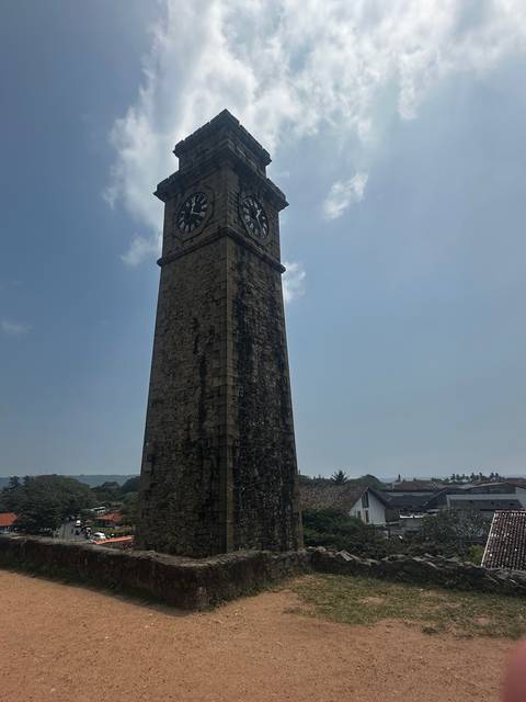 Historic clock tower under a clear blue sky.