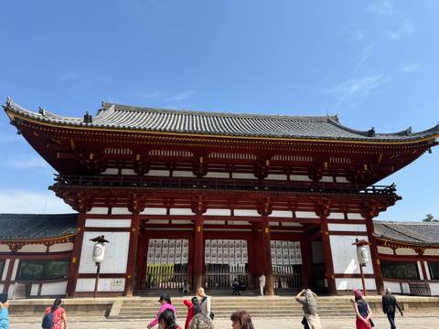 Traditional Japanese temple structure under a blue sky.