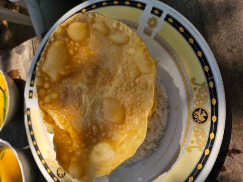 Close-up of rice and a crispy snack on a decorated plate.