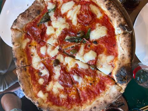 A traditional pizza topped with pepperoni, cheese, and olives.