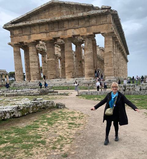 Tourists in front of ancient ruins.