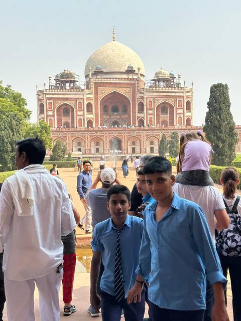 People standing in front of an ornate building.