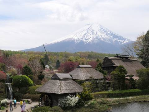 Traditional Japanese village with Mount Fuji in the background.