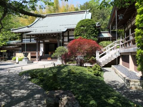 Traditional Japanese garden with a small temple.