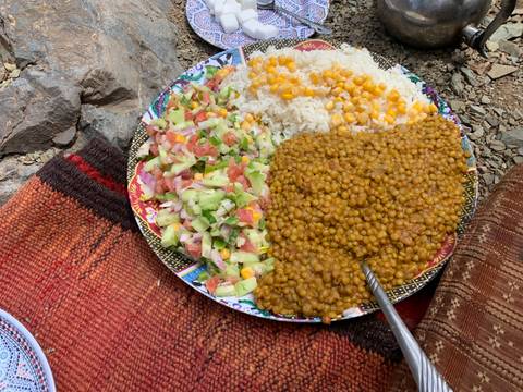 Plated meal with lentils, rice, and salad.