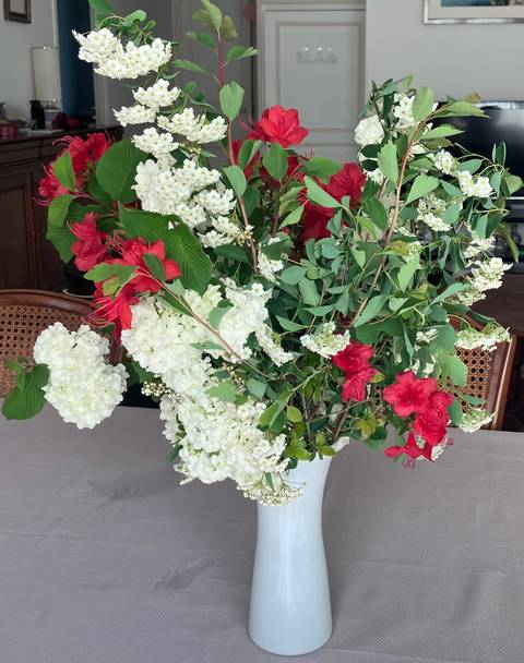 Arrangement of red and white flowers in a vase.