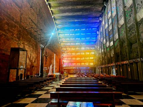 Colorful stained glass windows inside a brick church.