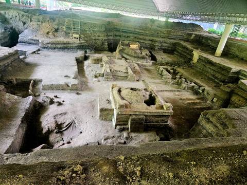 Archaeological excavation site with ancient structures.