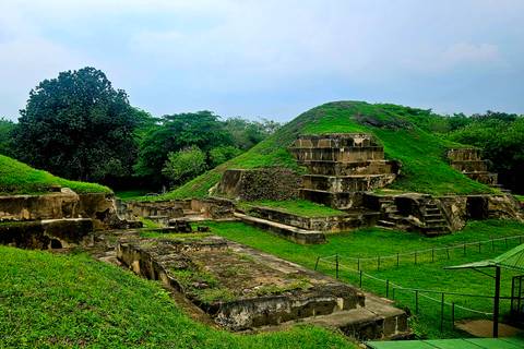 Ancient pyramid in lush surroundings.