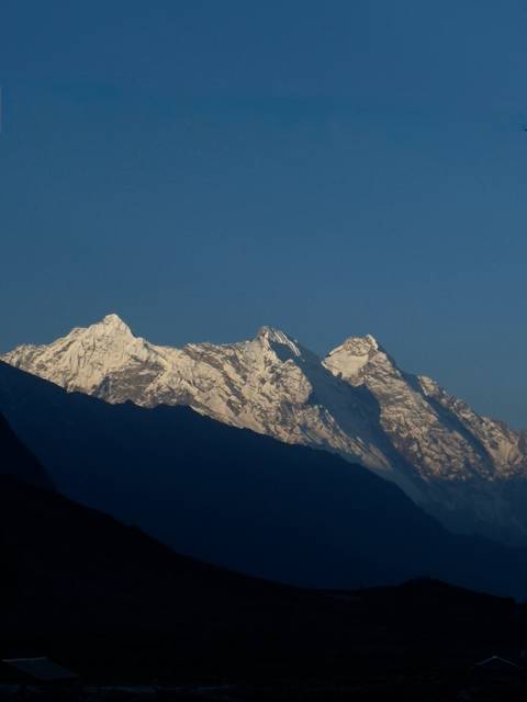 Mountain peaks covered in snow against a clear sky.