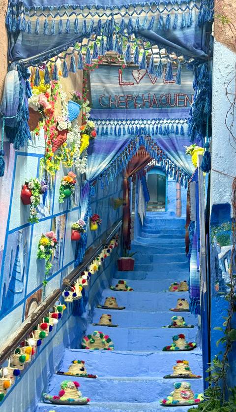 Colorful blue stairway accented with flowers and decoration.