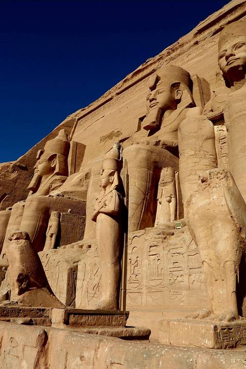 Statues of pharaohs carved into a mountainside.