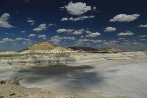 Dramatic landscape of white rocky formations under a blue sky.