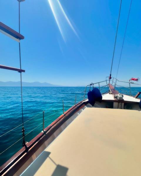 View from the bow of a boat on open water.