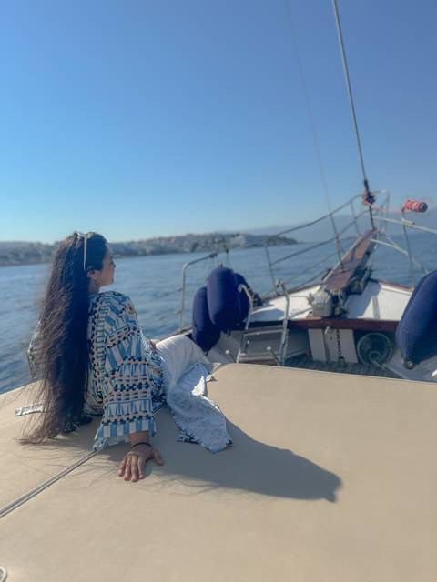 Person on a boat looking at the water.