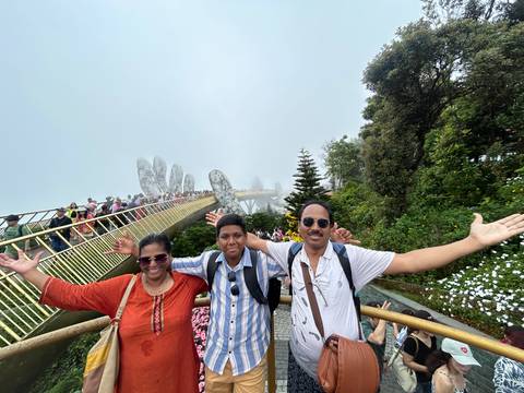Family posing on the Golden Bridge with foggy background.