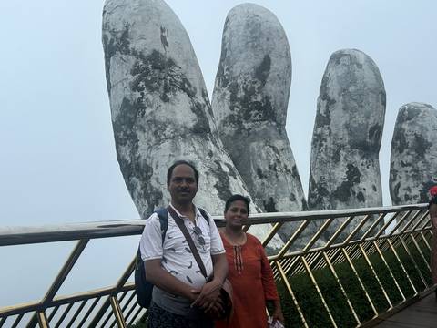 Couple posing on the Golden Hand Bridge.