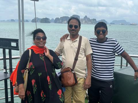 Family on a boat with a view of limestone karsts.