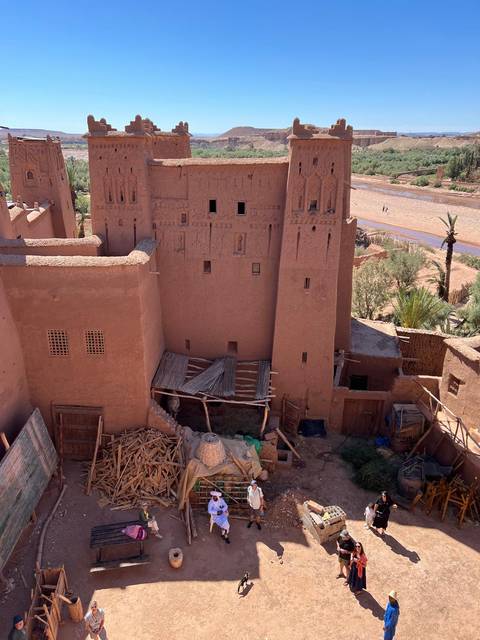 View of a historical building made of clay with wooden structures.