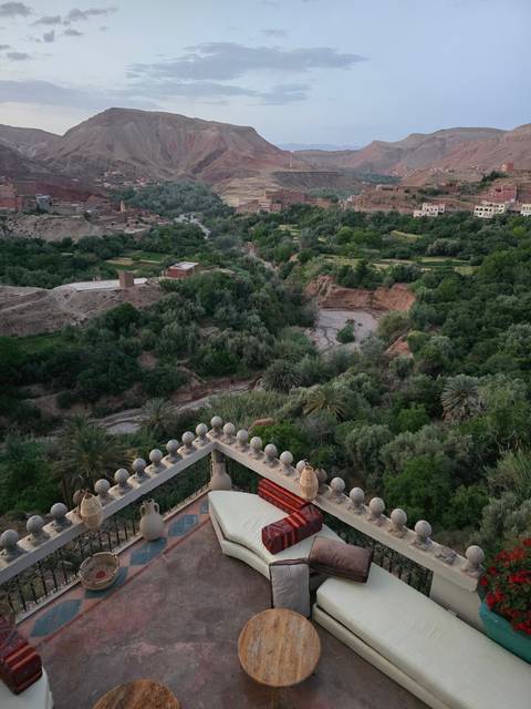 Lush green landscape with river and mountains.