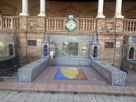 Woman posing at a beautifully decorated mosaic bench.