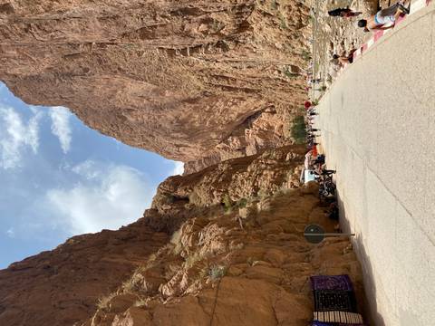 A scenic road through Todra Gorge with towering cliffs.