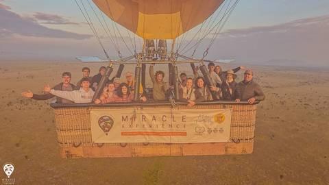 Group of people in a hot air balloon basket.