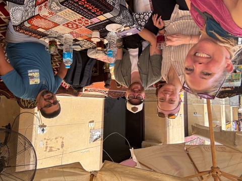 Group of people enjoying drinks at a cafe.