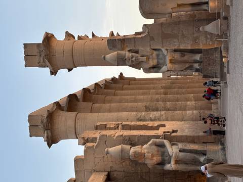 Ancient temple ruins with tourists.