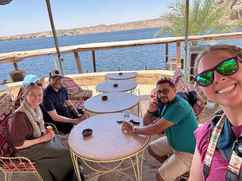 Group of travelers at a riverside café.