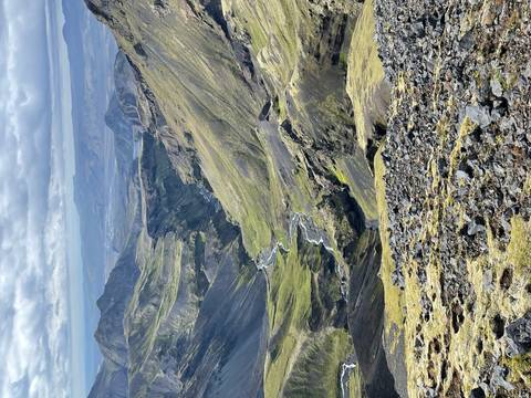 Expansive view of a mountainous valley with river.