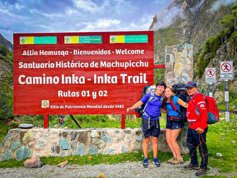 Hikers posing in front of a sign for the Inka Trail.