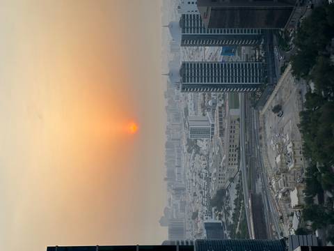 Sunset view over a city with visible buildings.
