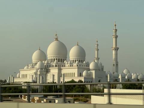 View of a grand mosque with large domes.