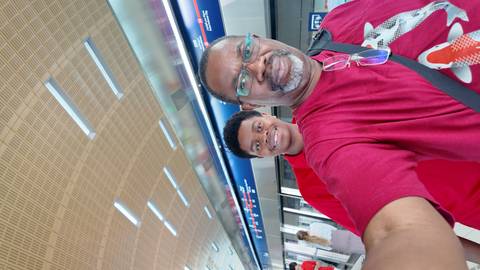 Two people at a modern train station.