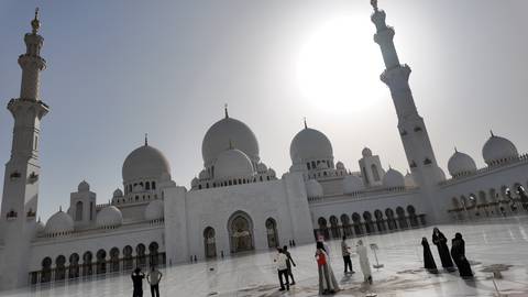 Courtyard of a mosque with visitors.