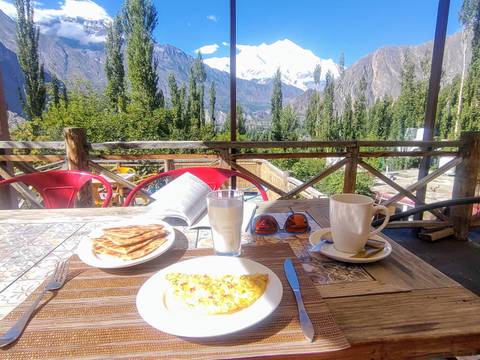Breakfast on a balcony with mountain views in the background.