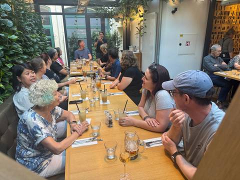 Group dining at a restaurant, engaged in conversation.