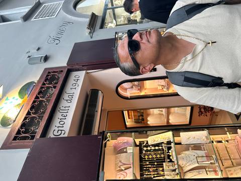 Person standing in front of a jewelry store entrance.