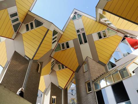 Innovative cubic architecture with yellow facades in an urban setting.