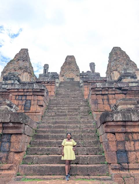 Grand stairway leading up to the entrance of ancient temple ruins.