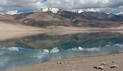 Mountainous landscape reflecting in a tranquil lake.