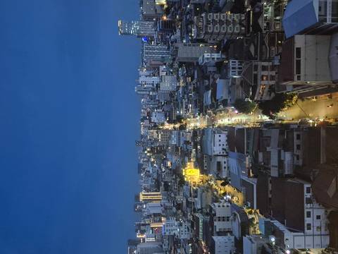Cityscape at night with illuminated streets.