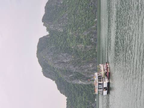 Docked boats in Halong Bay with limestone formations.