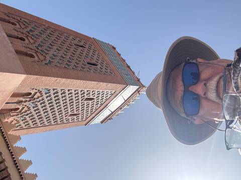 Upside-down image of a man in a hat with a building.
