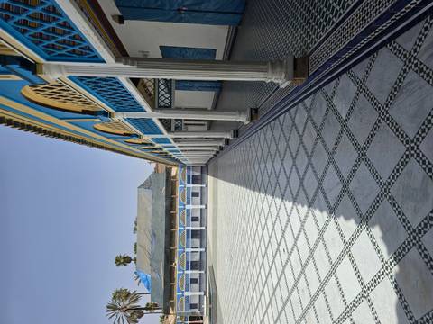 Interior palace view with arches and tiled floor.