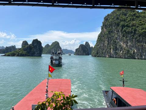 Boats navigating the waters between limestone karsts.