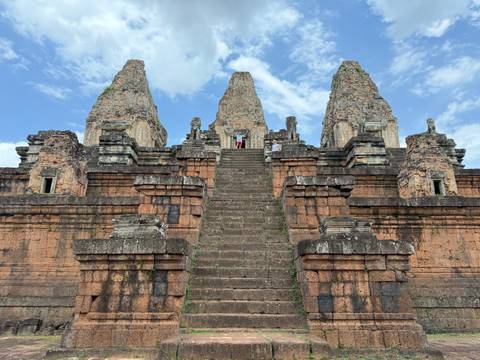 Ancient stone temple with steep steps and ornate carvings.